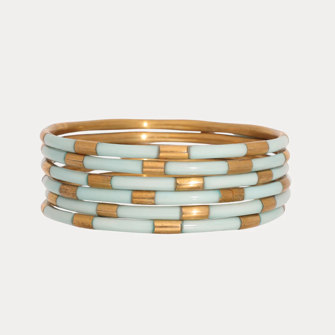 Stack of gold and mint Budhagirl Veda bangle bracelets