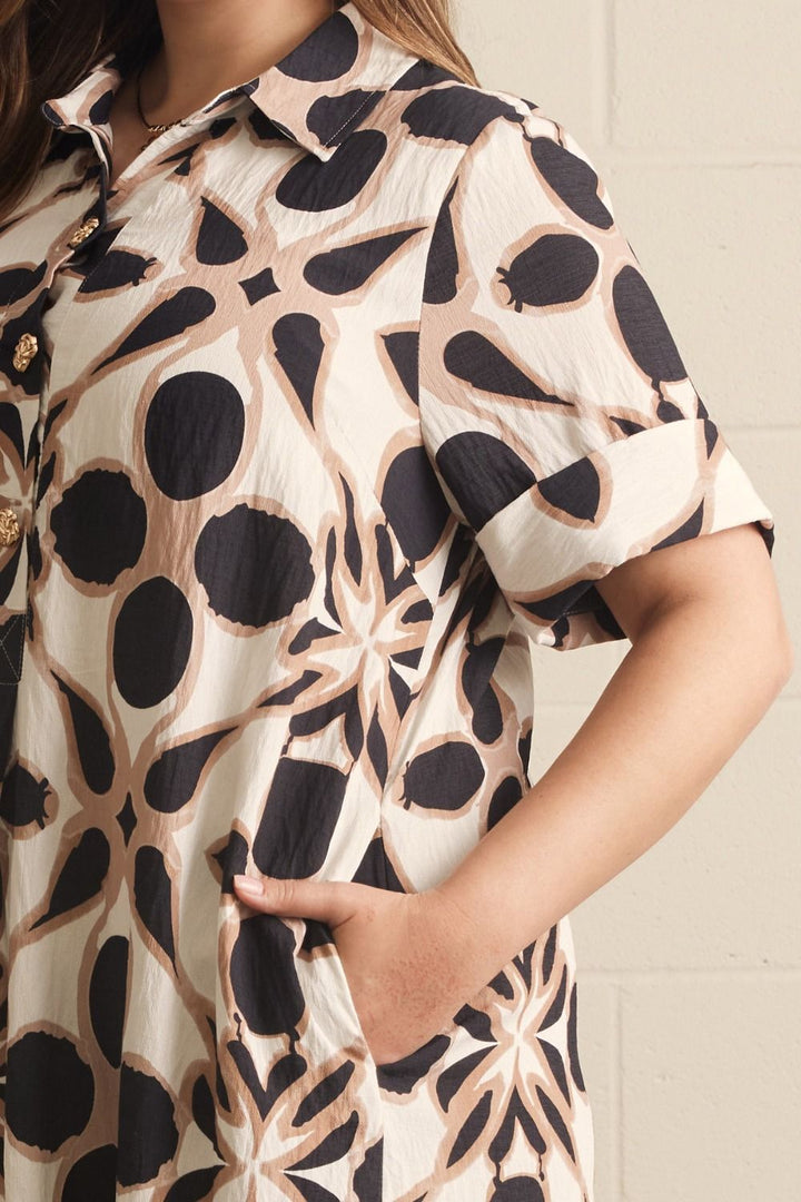 close up of Entro plus size ivory and black printed midi dress