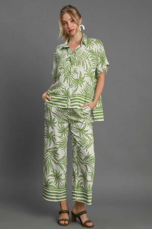 Umgee cream top with green palm tree print accented with metallic gold