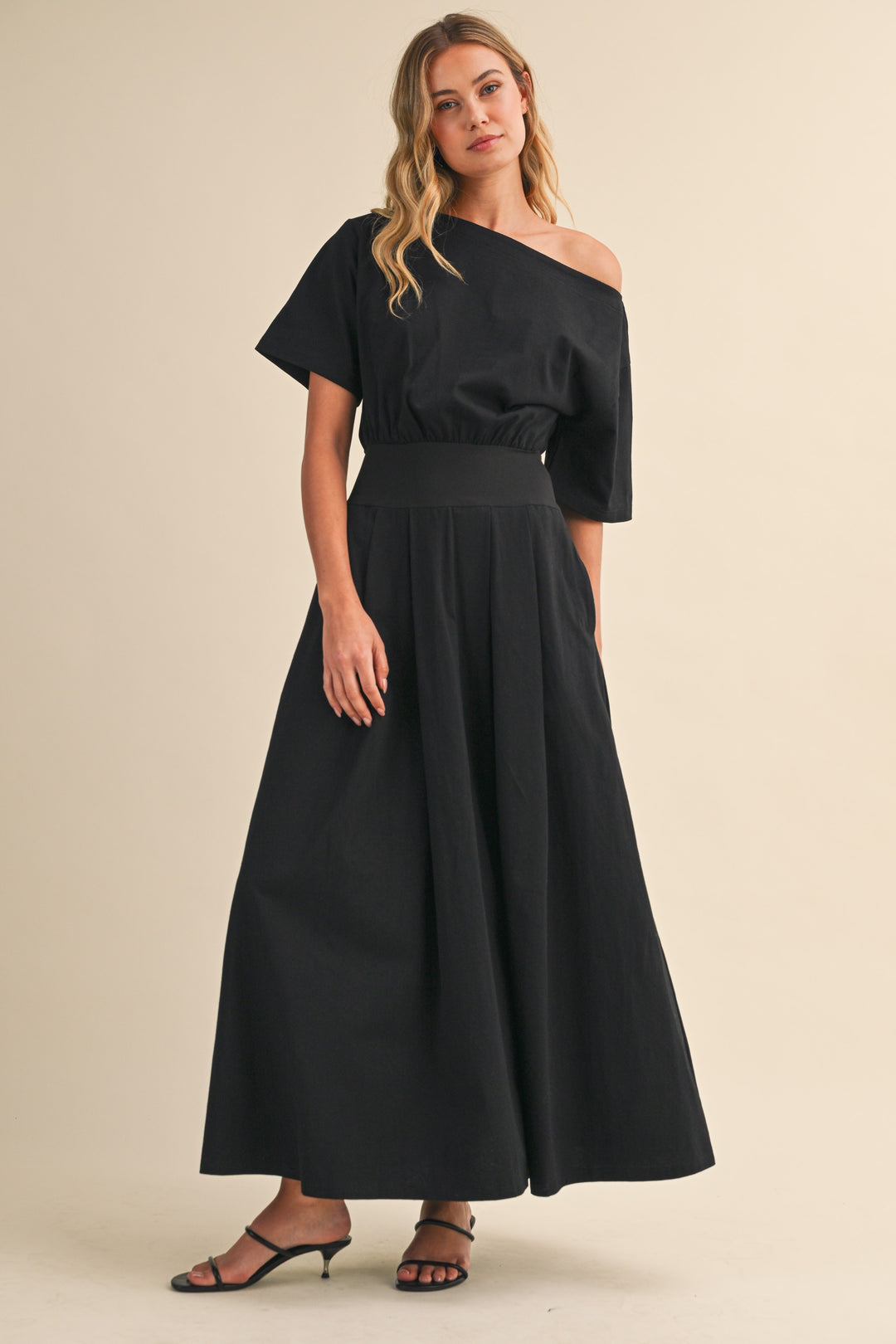 Black midi dress with boat neck and cinched waist by Klesis with a flowy skirt