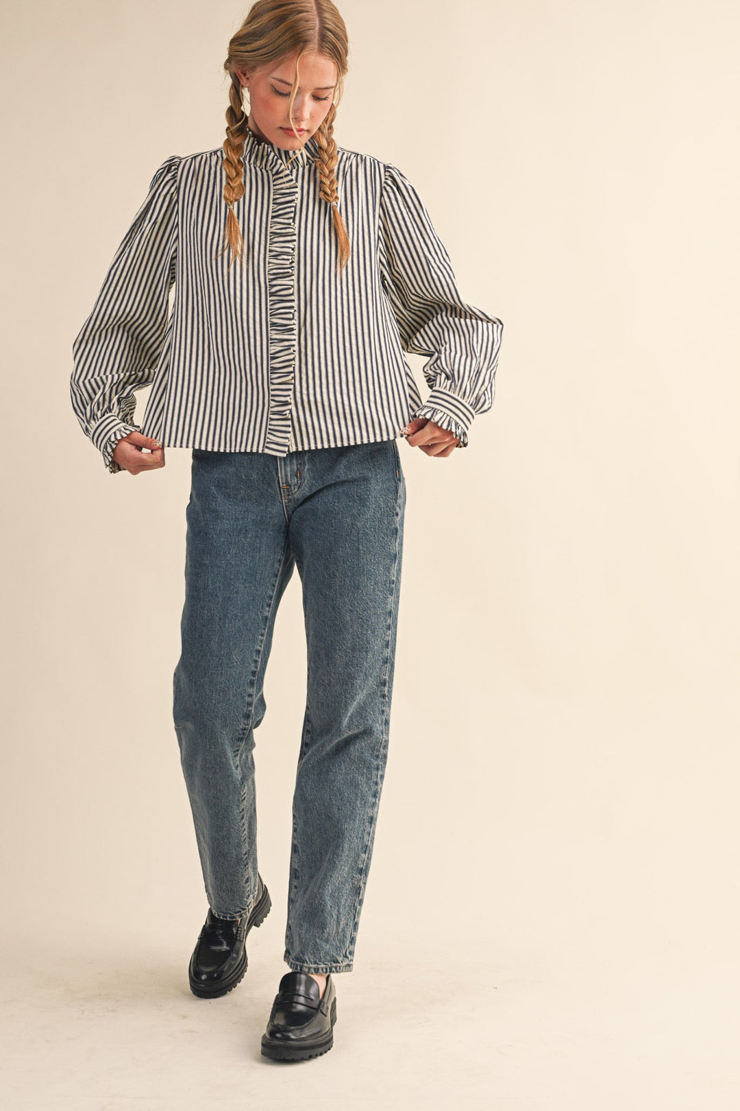 Women's black and cream striped button front top with ruffle trim details by &merci showing view of shirt width