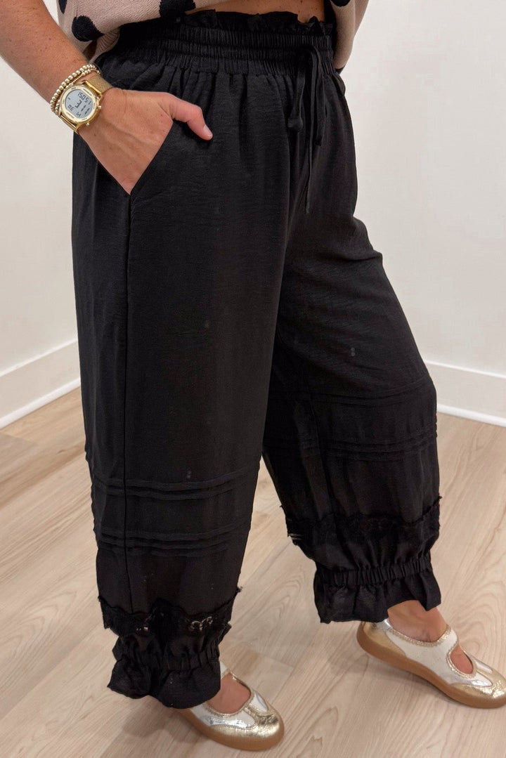 solid black elastic waist wide leg cropped pants with elastic ruffle cuffed ankles and front pockets
