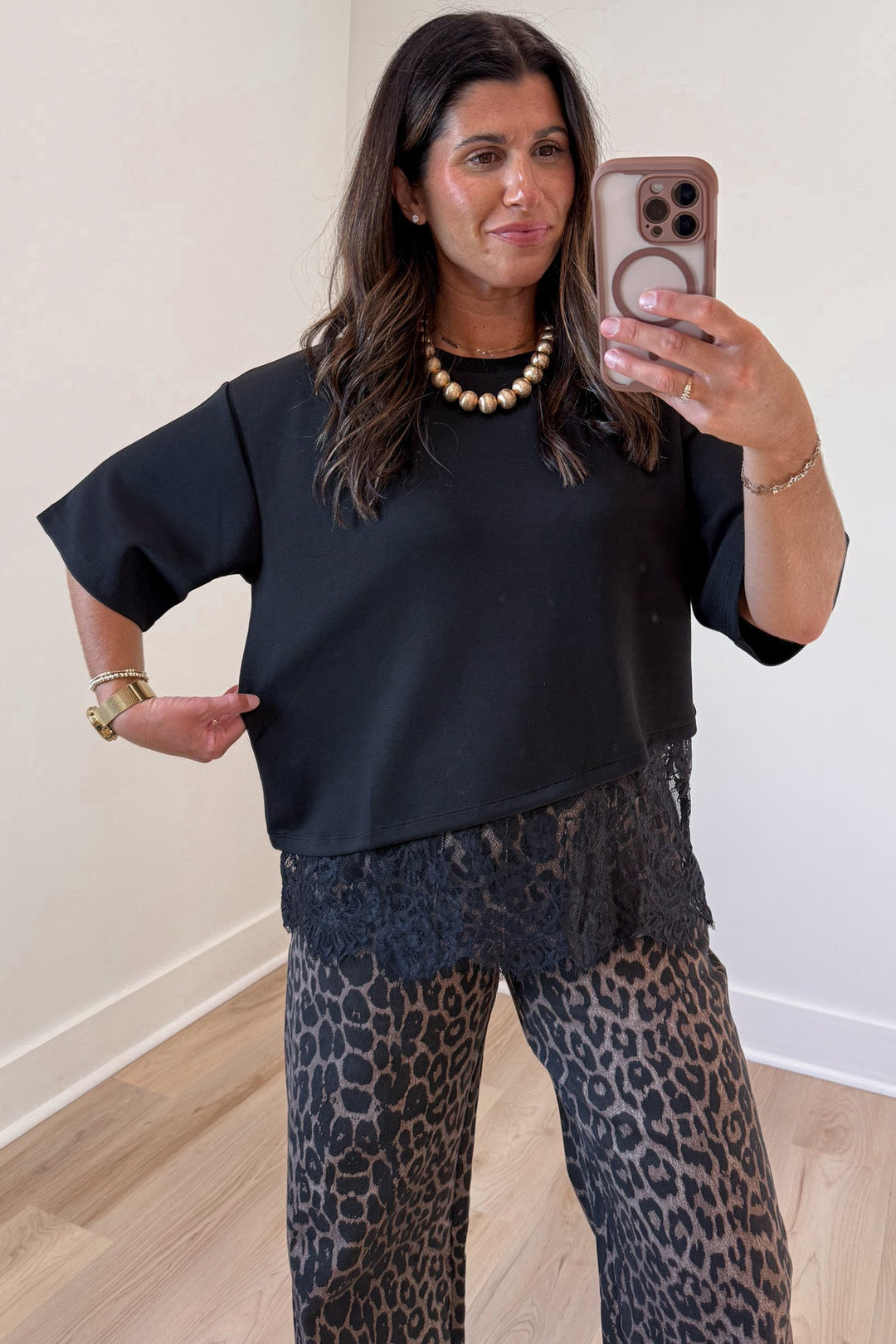 solid black asymmetrical tiered lace hem short sleeve crew neckline relaxed fit top