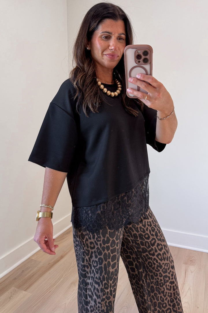 solid black asymmetrical tiered lace hem drop shoulder short sleeve crew neckline top