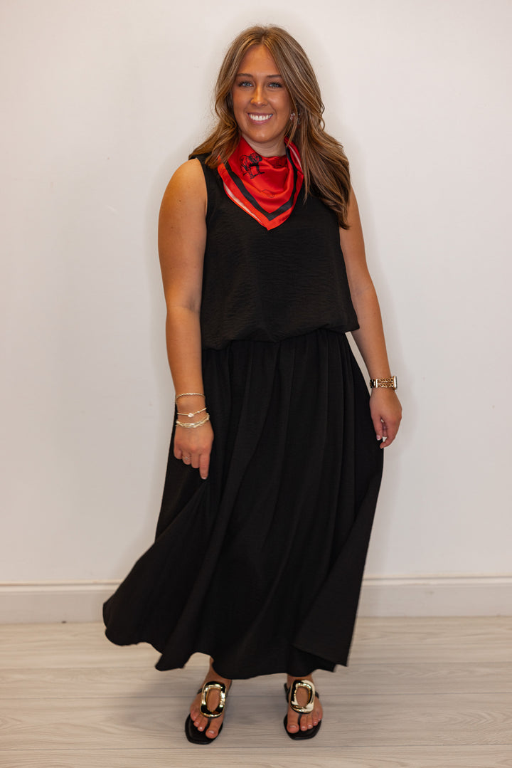 Women's black textured bubble hem sleeveless crop top by Entro shown with matching skirt