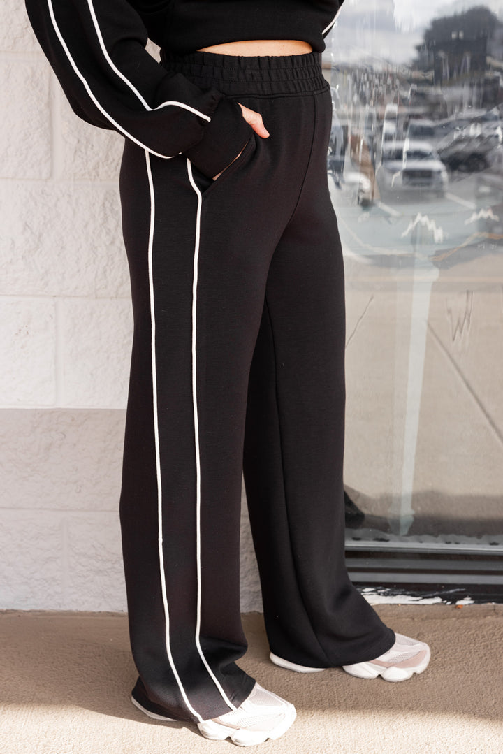 Women's black scuba knit straight leg elastic waist pants by Rae Mode showing up close, side view