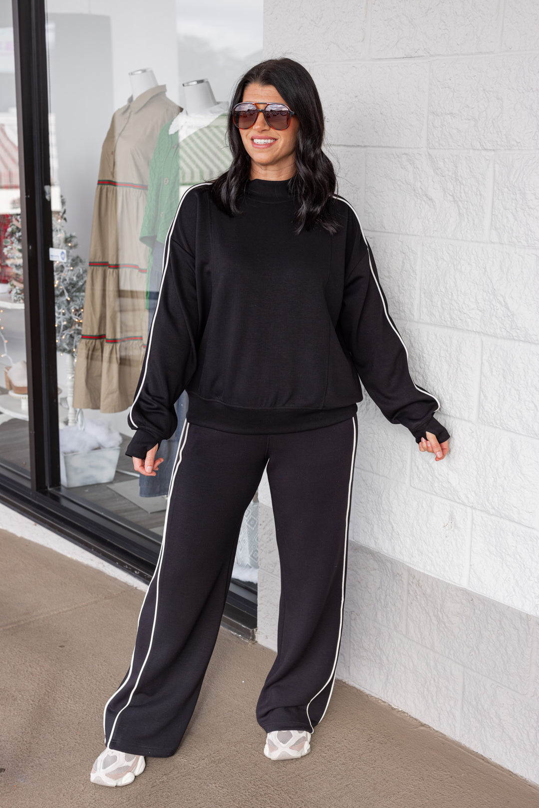 Women's black scuba knit straight leg elastic waist pants by Rae Mode showing full front view