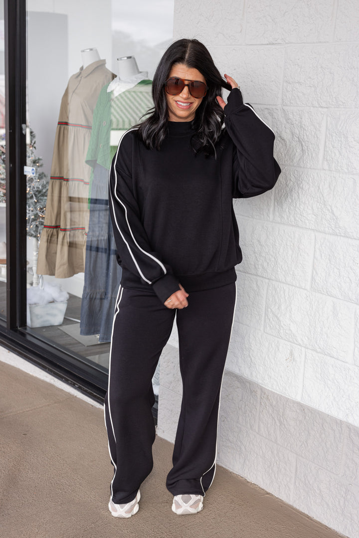 Women's black scuba knit mock neck top by Rae Mode, shown with matching pants