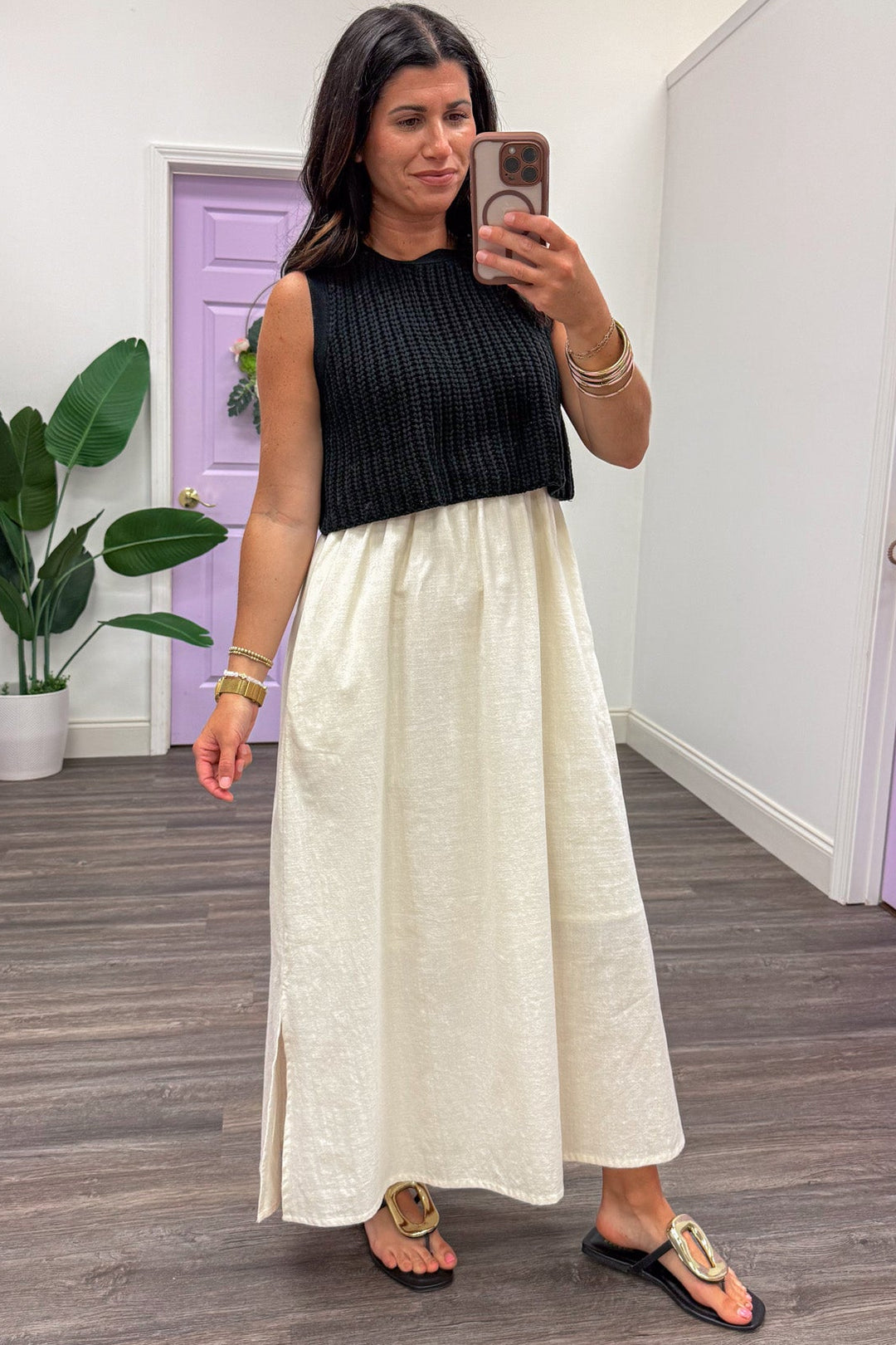 midi dress with black sleeveless sweater top and cream cotton skirt