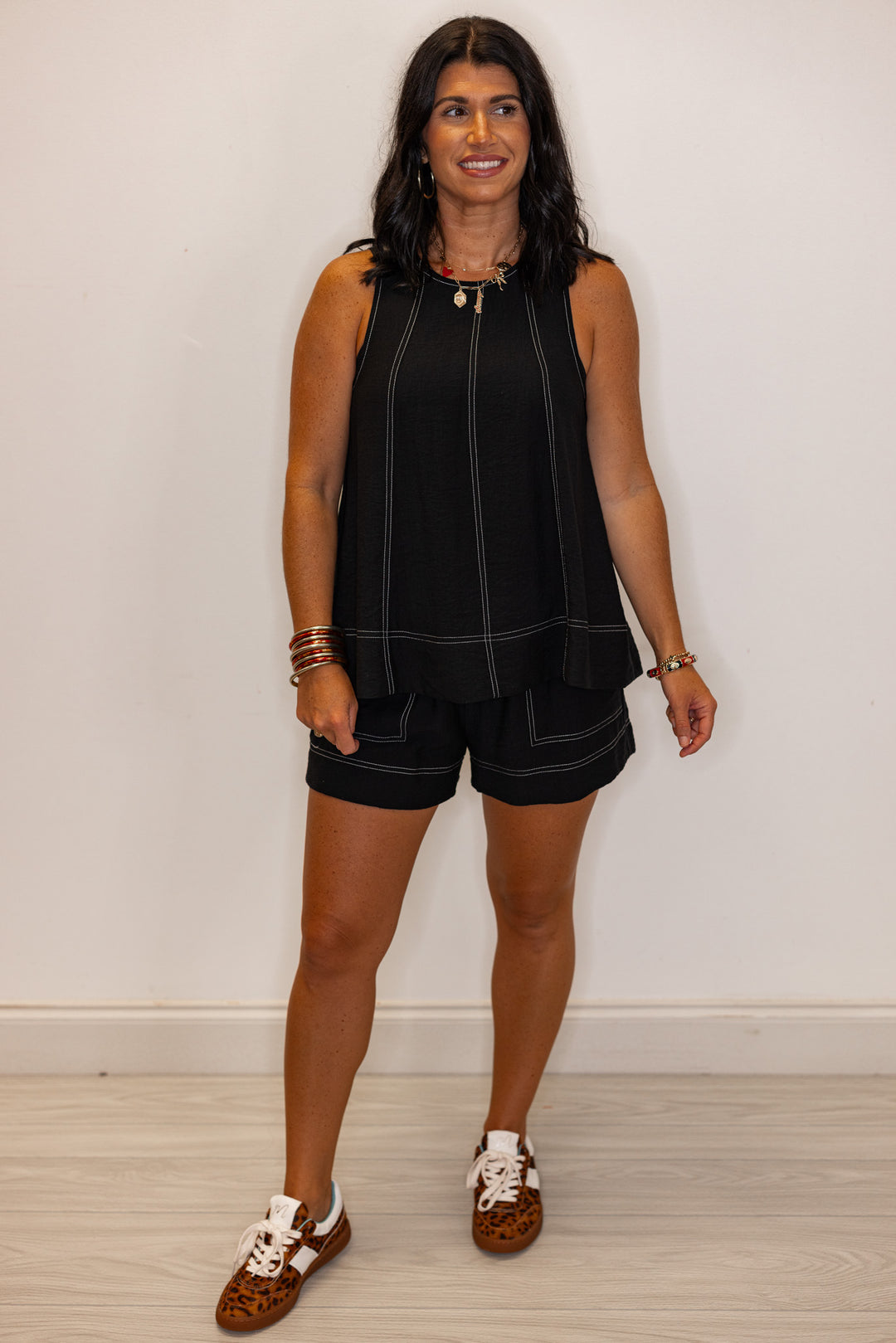 Black elastic waist shorts with white stitching by Entro showing full front view