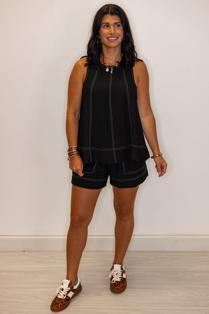Black elastic waist shorts with white stitching by Entro showing full front view