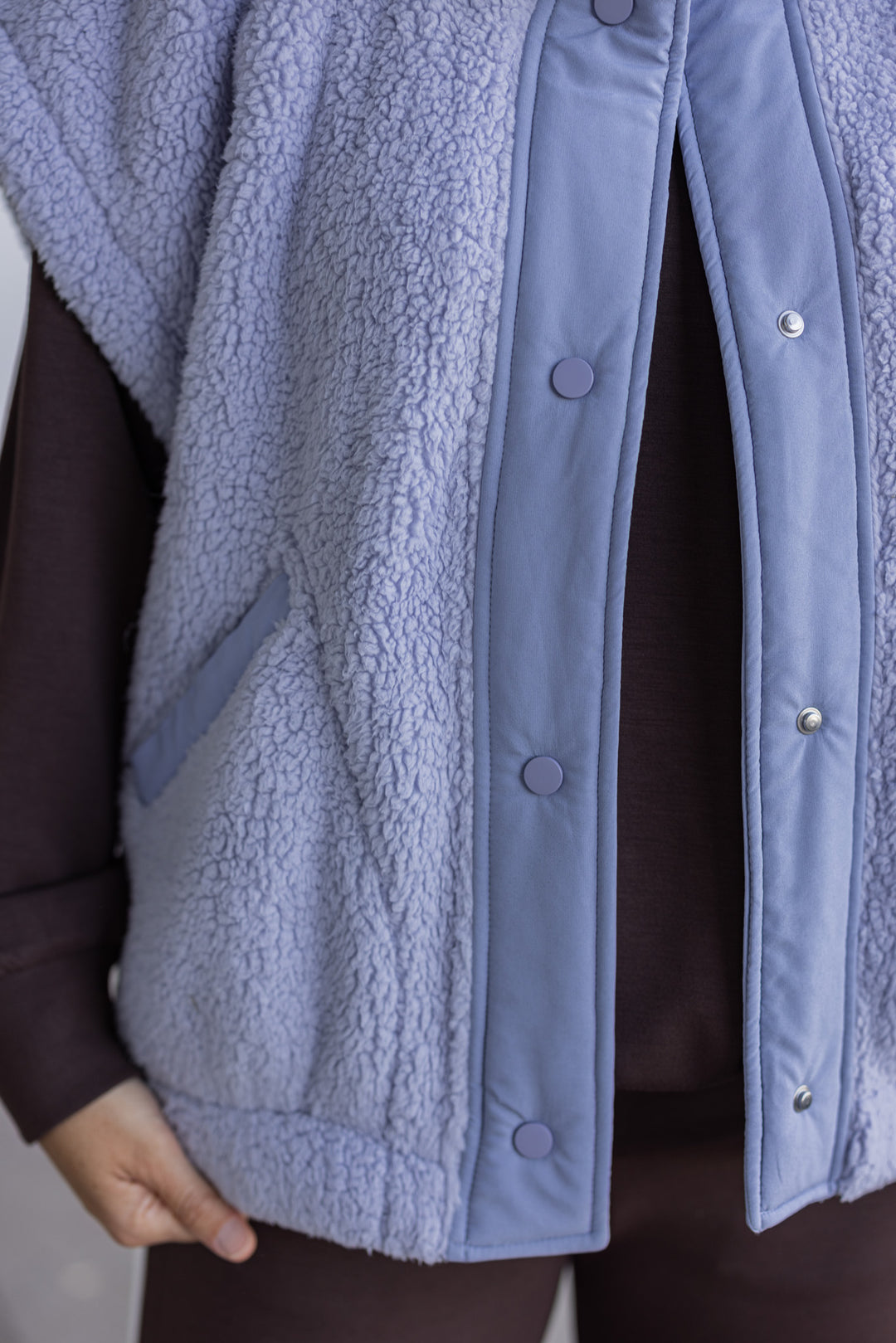 Women's light blue sherpa vest by Rae Mode showing up close of button closures