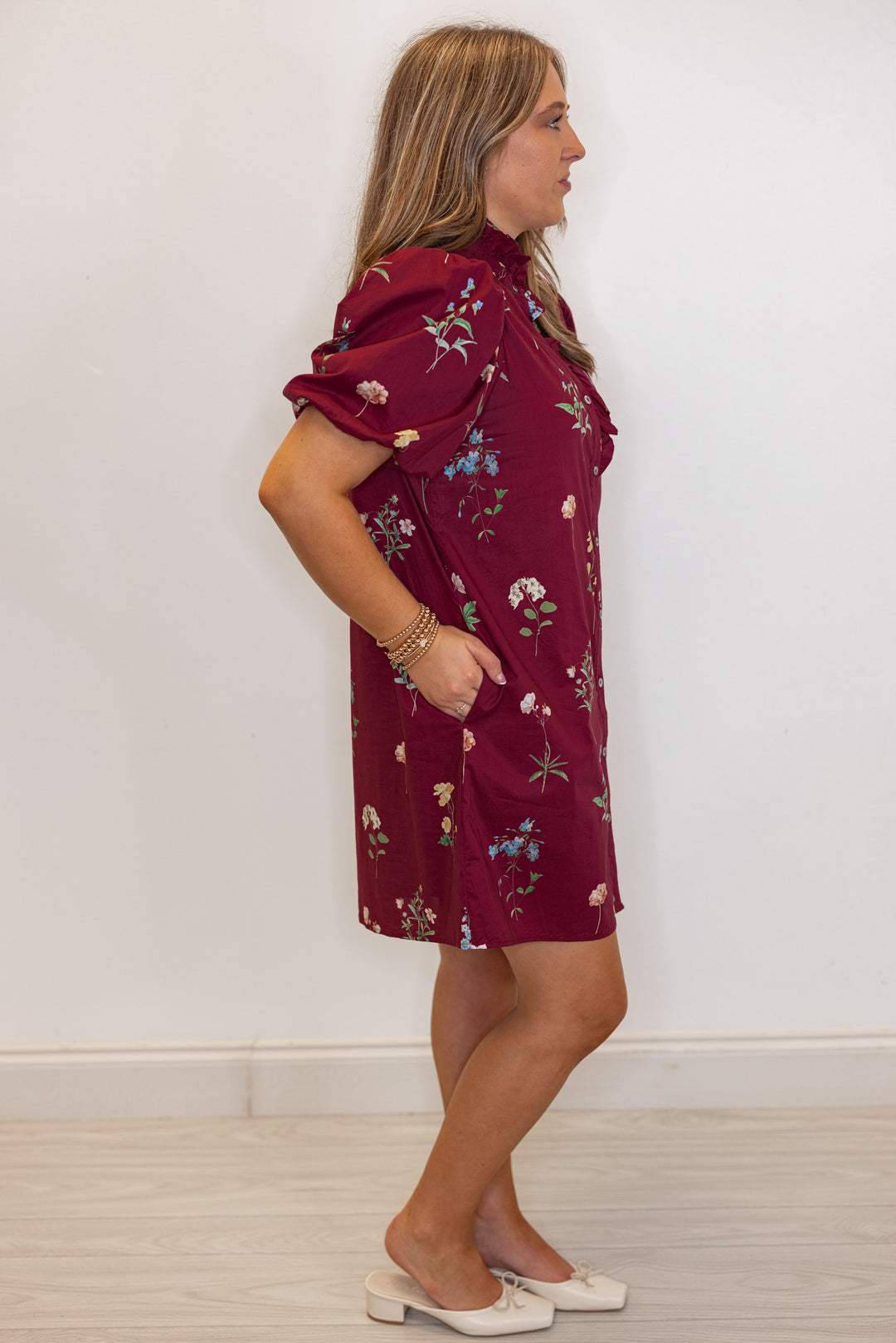 Women's burgundy multicolor floral print button front poplin dress with ruffle detail by Entro showing full side view