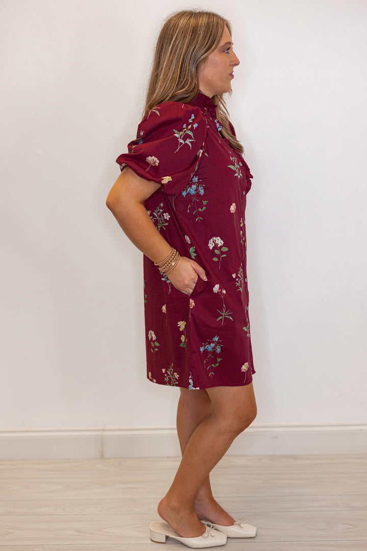 Women's burgundy multicolor floral print button front poplin dress with ruffle detail by Entro showing full side view