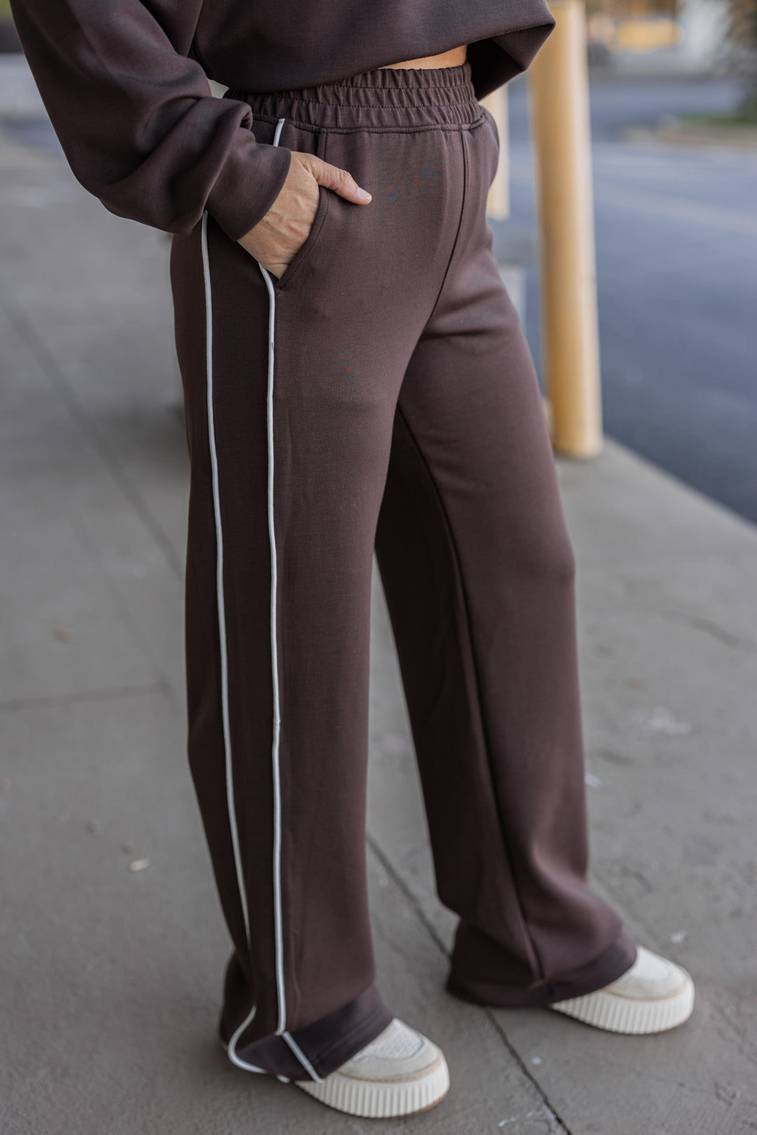 Women's chocolate brown scuba knit straight leg elastic waist pants by Rae Mode showing side view