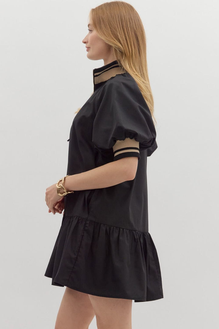 Women's black zipper dress with black and tan ribbed trim by Entro showing side view