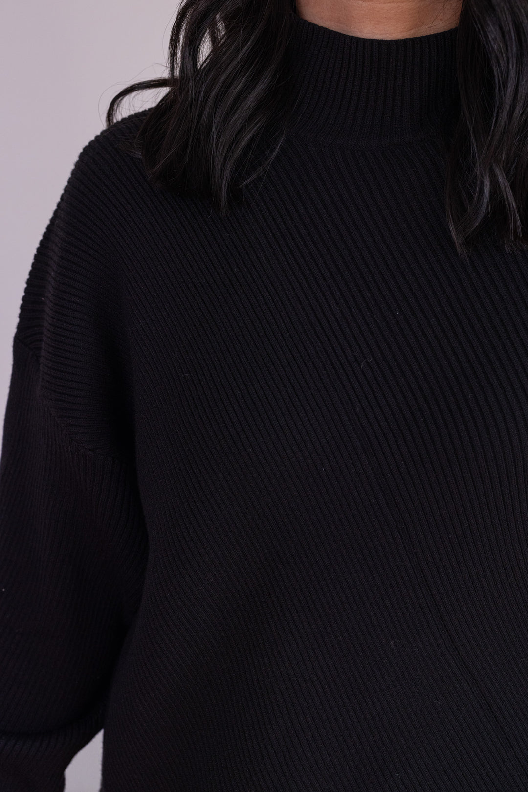 Women's black diagonal ribbed knit sweater top by Hyfve showing mock neckline