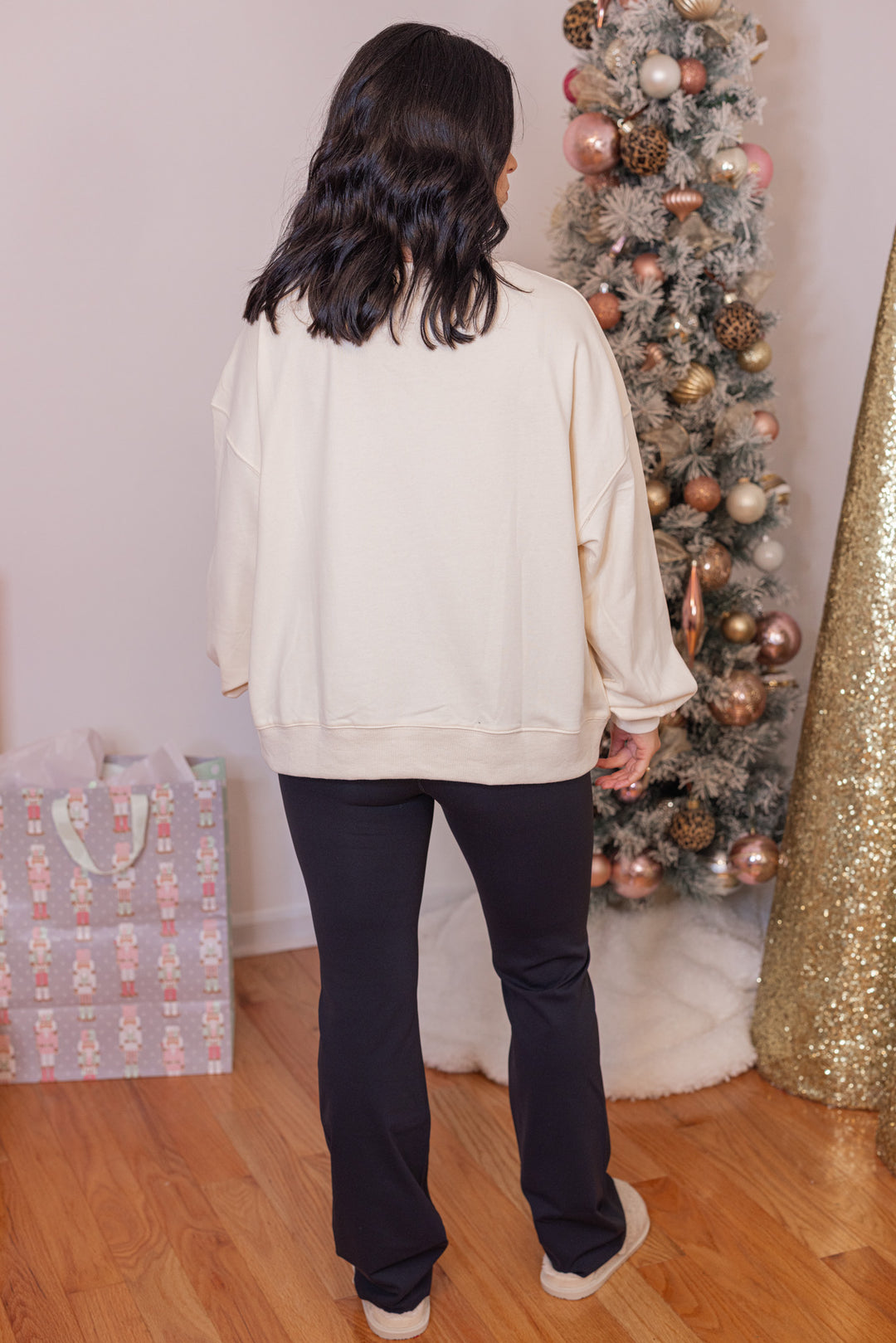 Women's cream corduroy patch sweatshirt with a nutcracker and Christmas tree by Peach Love California showing full back view