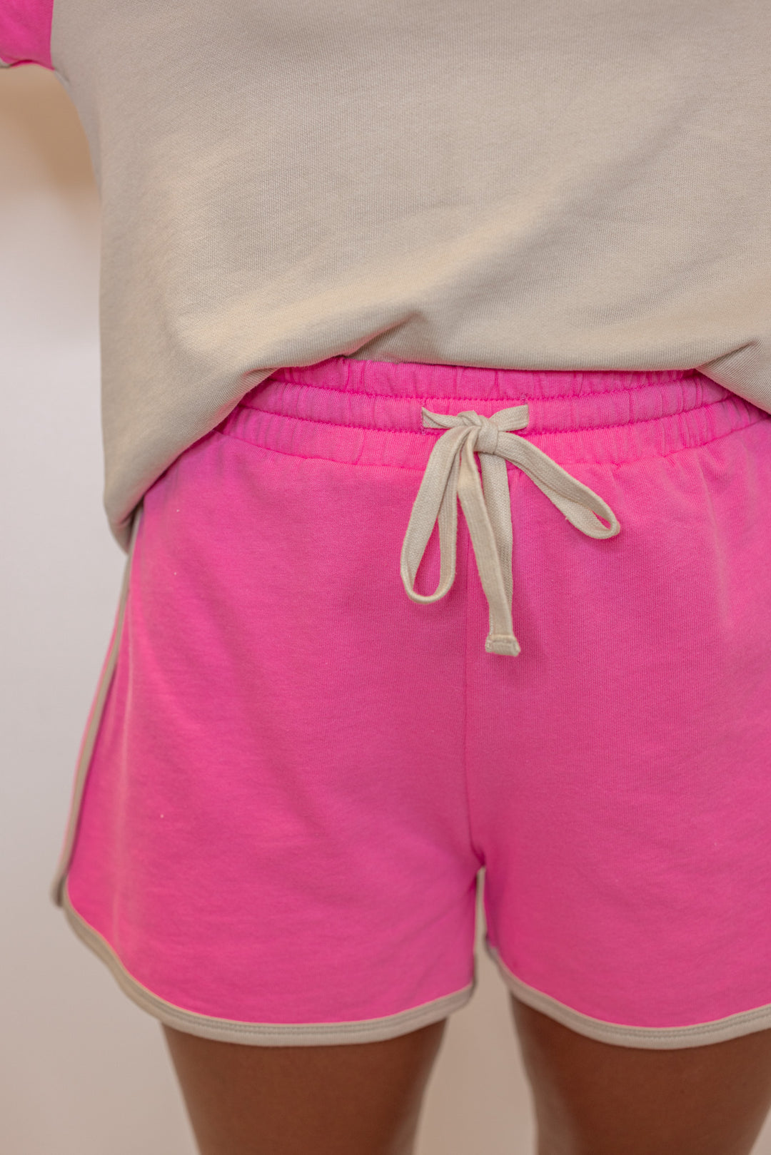 Women's light mocha and punch pink terry knit colorblock top and shorts set by Wishlist showing up close front view of shorts