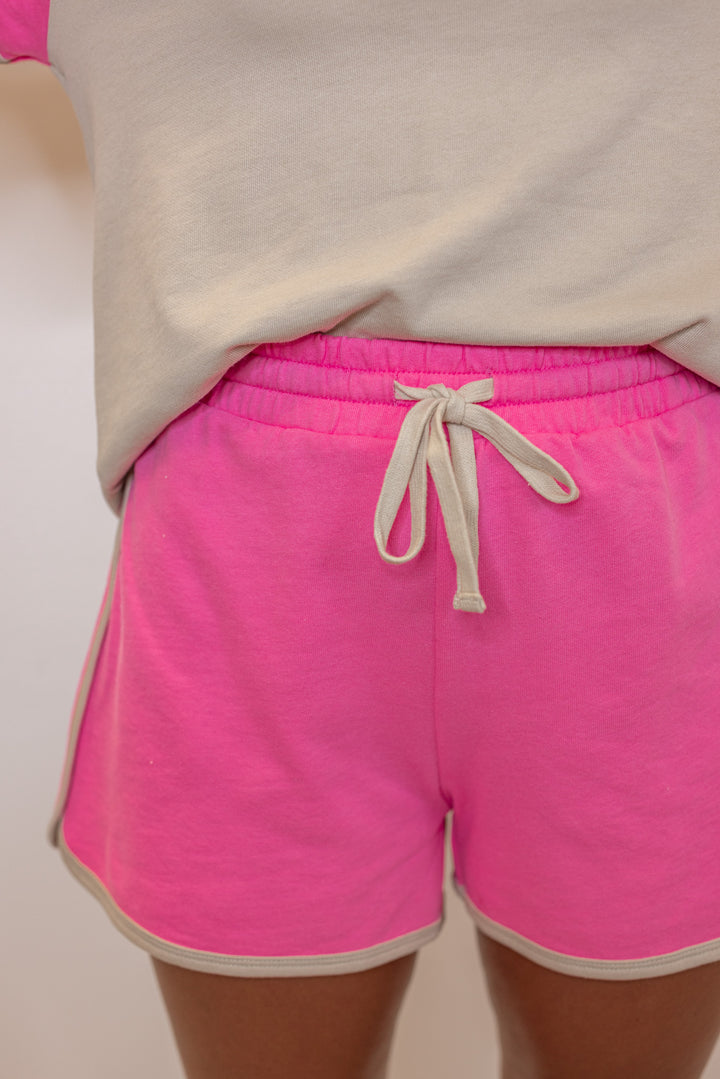 Women's light mocha and punch pink terry knit colorblock top and shorts set by Wishlist showing up close front view of shorts