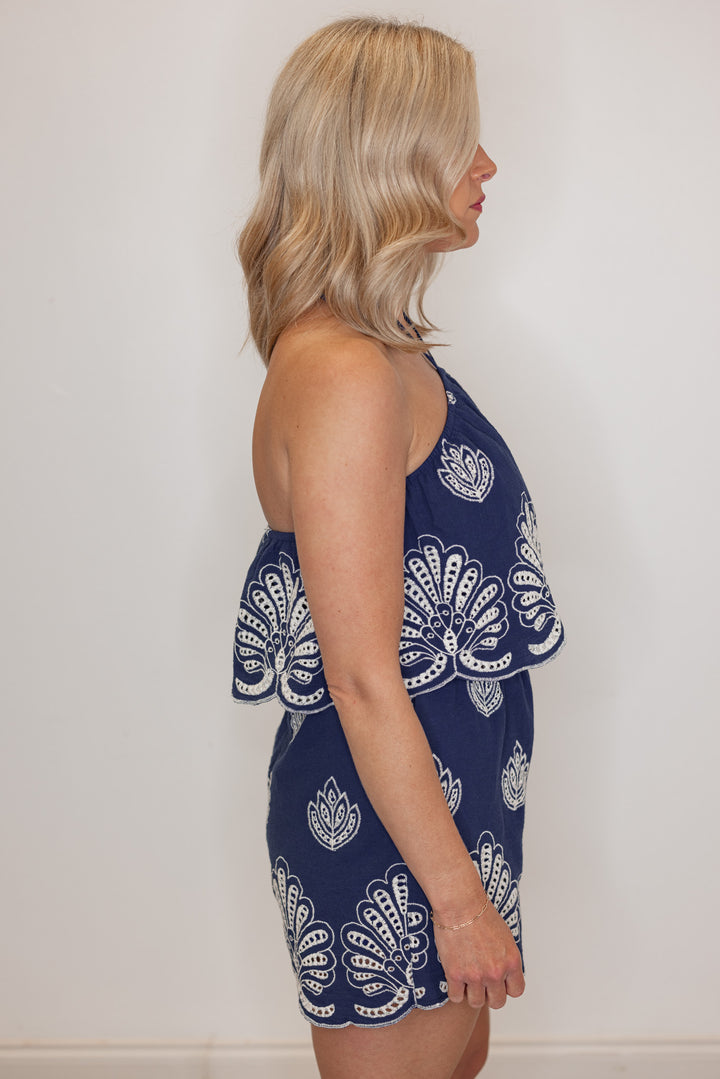 Women's navy halter romper with cream eyelet details by Illa Illa showing full side view