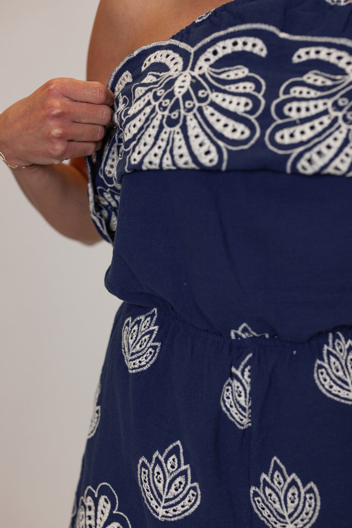 Women's navy halter romper with cream eyelet details by Illa Illa showing up close embroidered detailing 