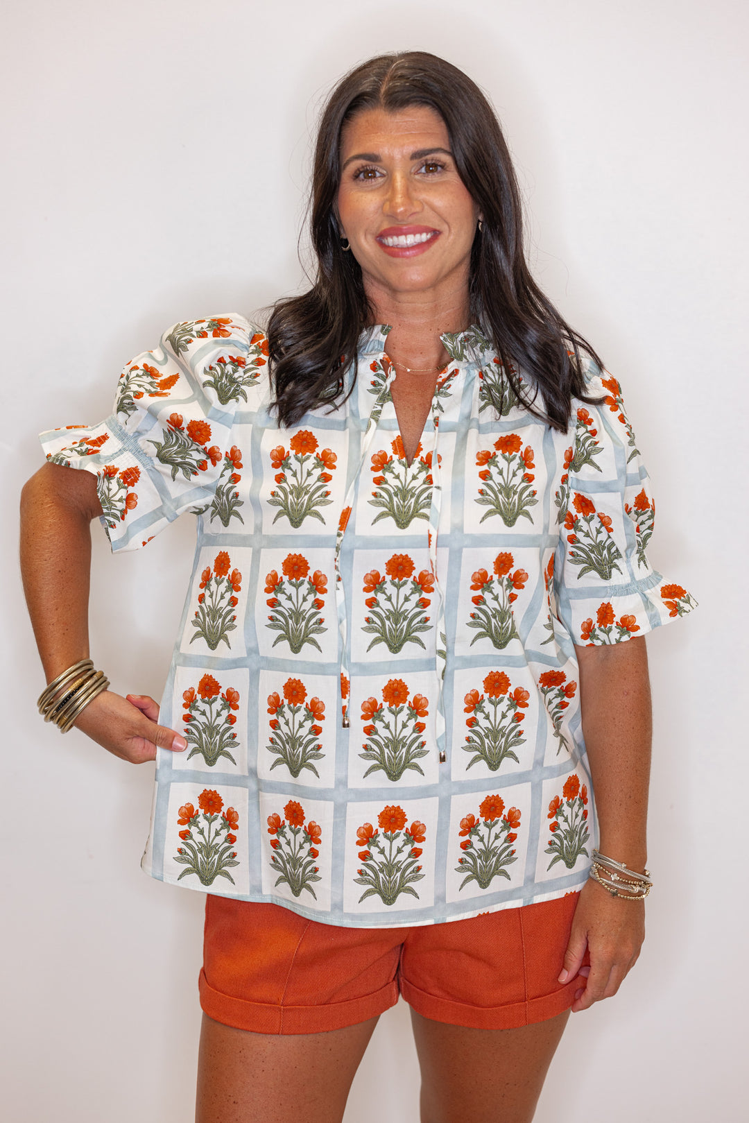 Cream top with orange floral print in light washed teal squares by Entro showing relaxed silhouette 