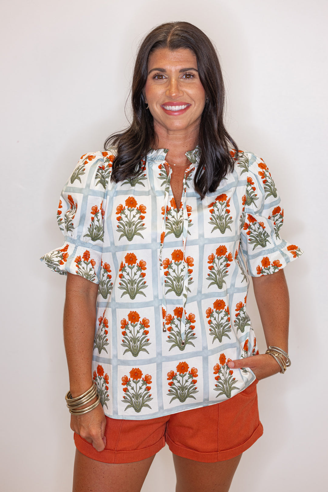 Cream top with orange floral print in light washed teal squares by Entro