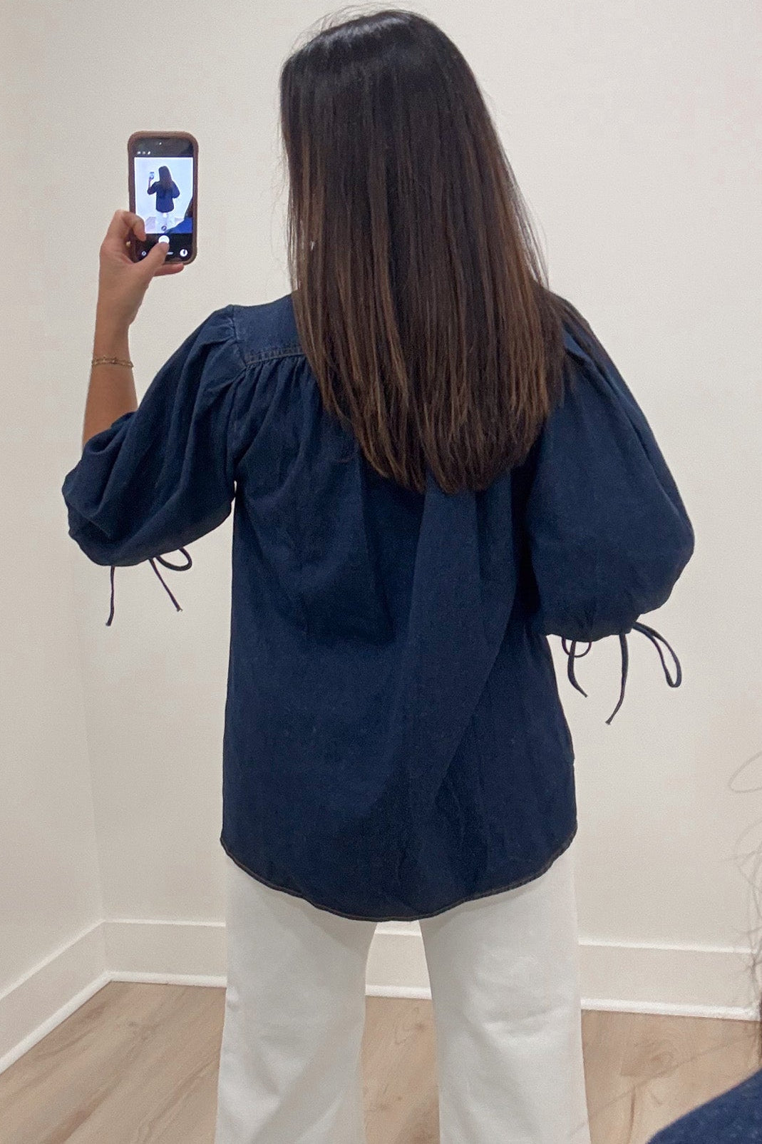 solid dark blue denim 3/4 length puff sleeve mock neckline button front bodice top with gathered back detail