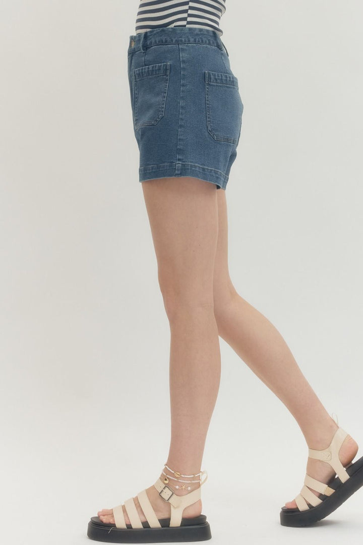 Women's dark washed blue denim shorts by Entro showing side view