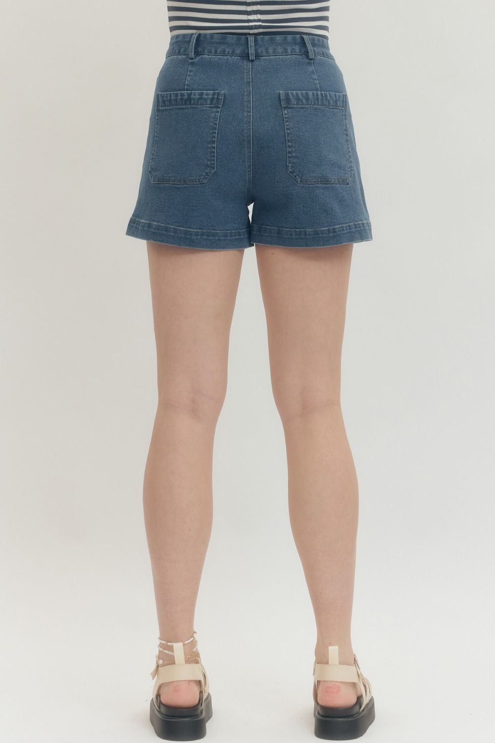 Women's dark washed blue denim shorts by Entro showing back view