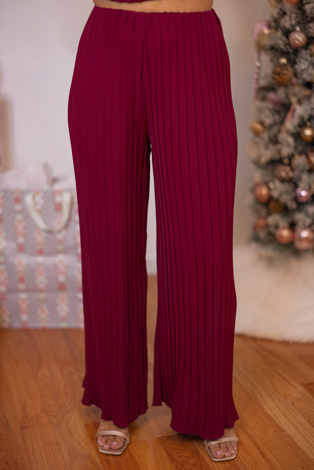 Women's holiday wear burgundy pants set by Wishlist showing pant's up close front view
