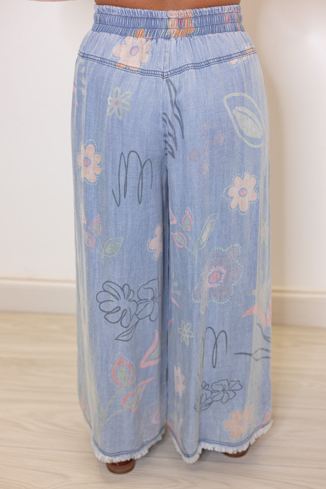 Women's washed light blue floral print wide leg palazzo chambray denim pants by Easel showing up close back view