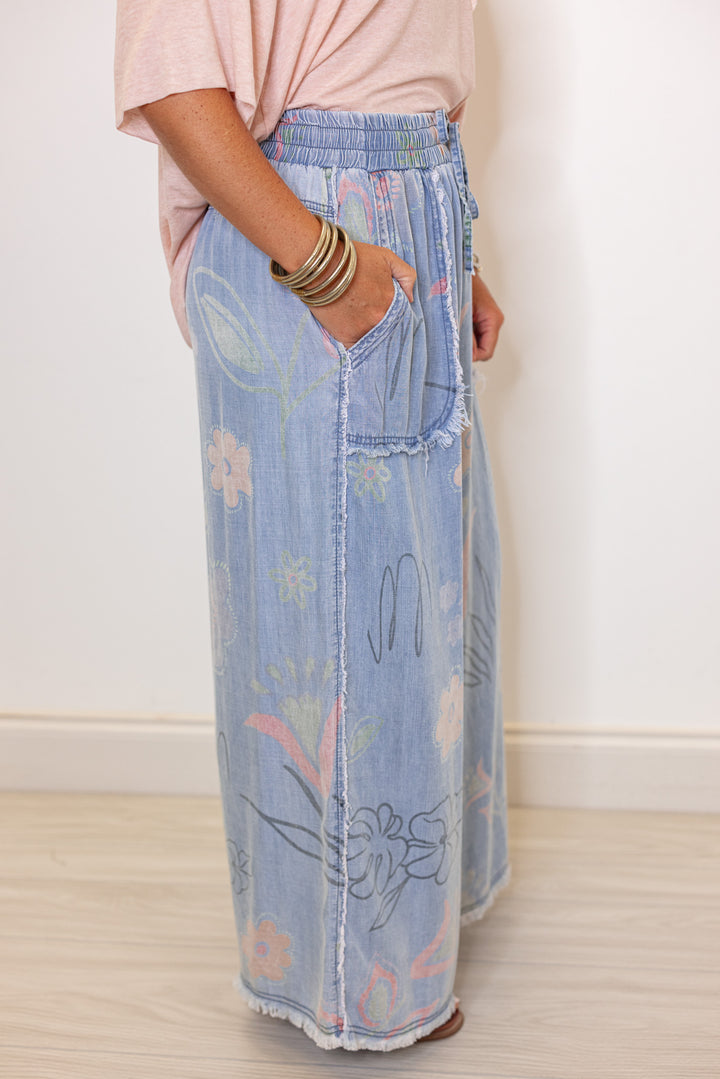 Women's washed light blue floral print wide leg palazzo chambray denim pants by Easel showing up close side view