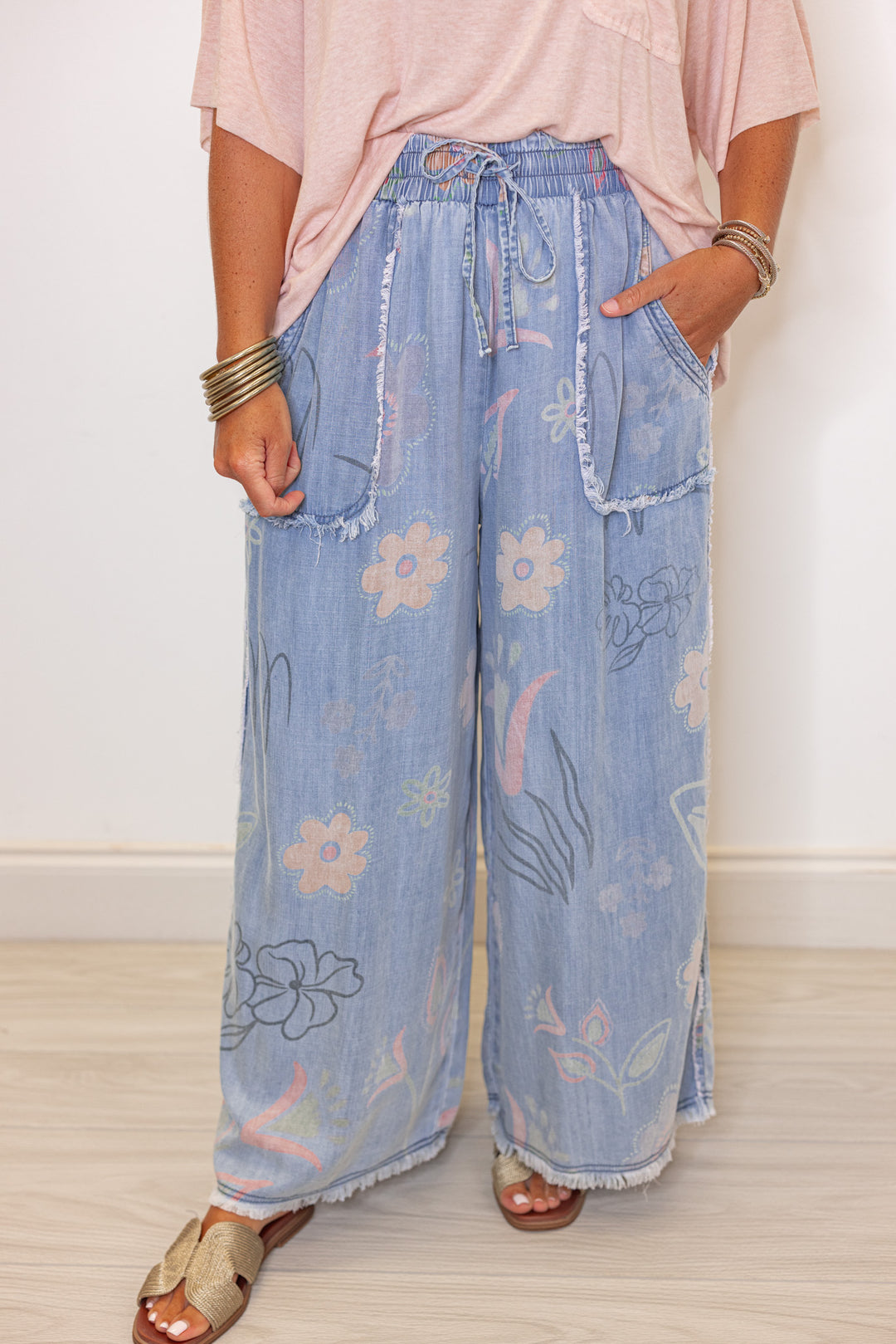 Women's washed light blue floral print wide leg palazzo chambray denim pants by Easel showing up close front view