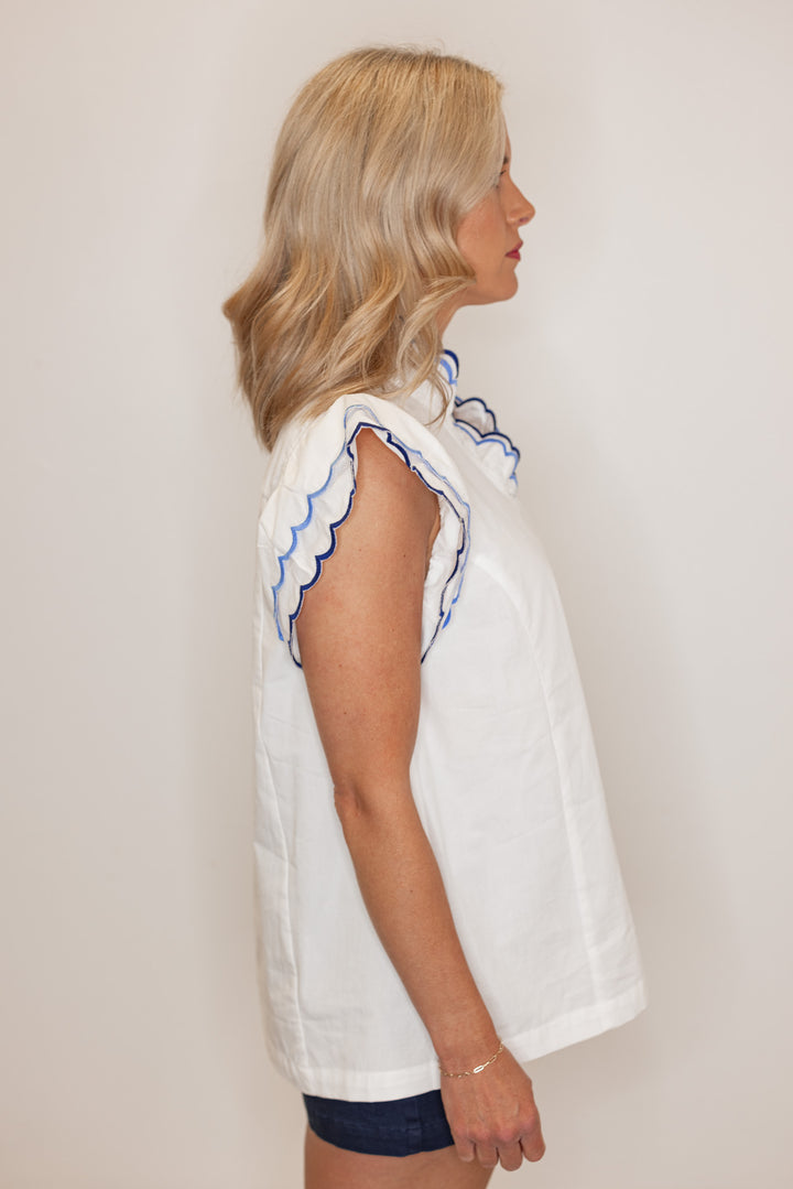 Women's summer off white poplin top with blue and navy scalloped trim by Umgee showing side view