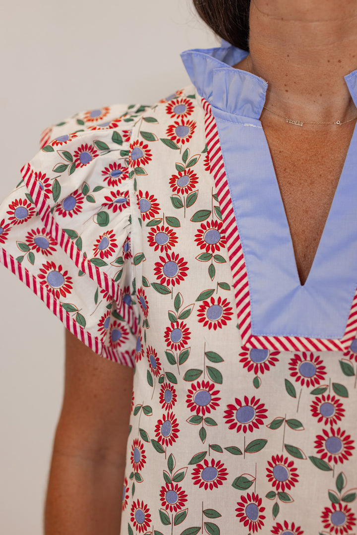 Women's cream poplin top with red, light blue and green floral print by Entro showing up close front view