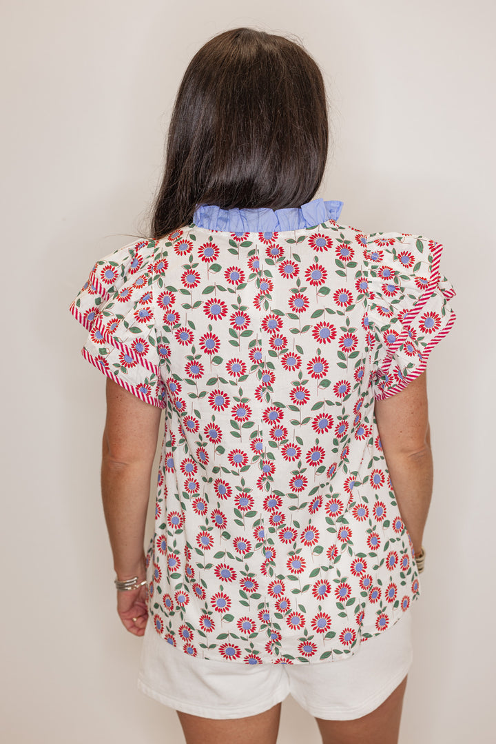 Women's cream poplin top with red, light blue and green floral print by Entro showing back view