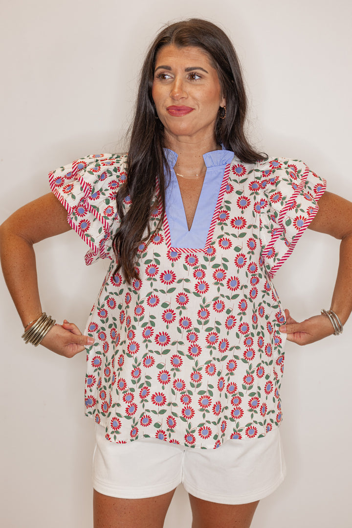 Women's cream poplin top with red, light blue and green floral print by Entro showing front view