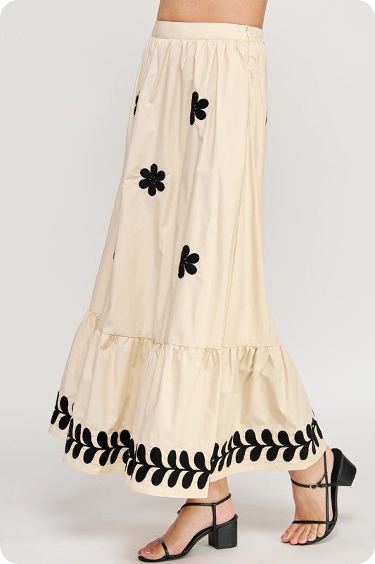 Women's poplin Summer maxi skirt in ecru with black floral print shown in side view