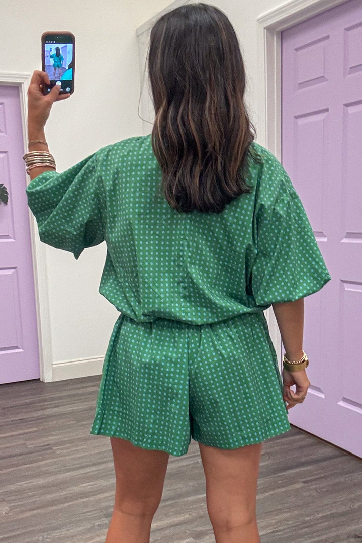green with small blue polka dot print bubble hem semi-cropped top with back keyhole button closure