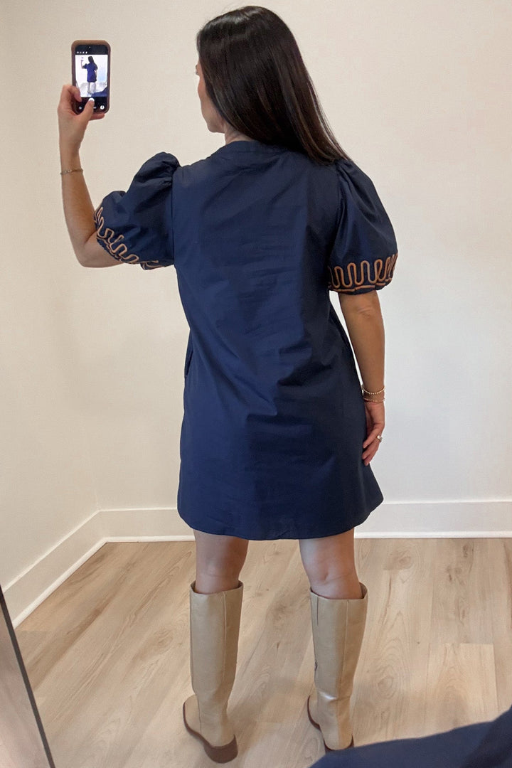 navy blue with caramel embroidery accents cuffed short puff sleeve v neckline shift dress
