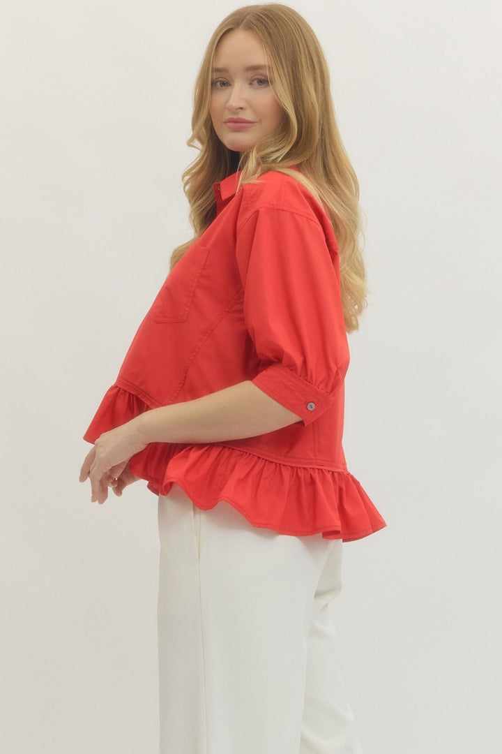 Women's semi-cropped button down red peplum top with ruffled hem by Entro showing the side view and sleeve.