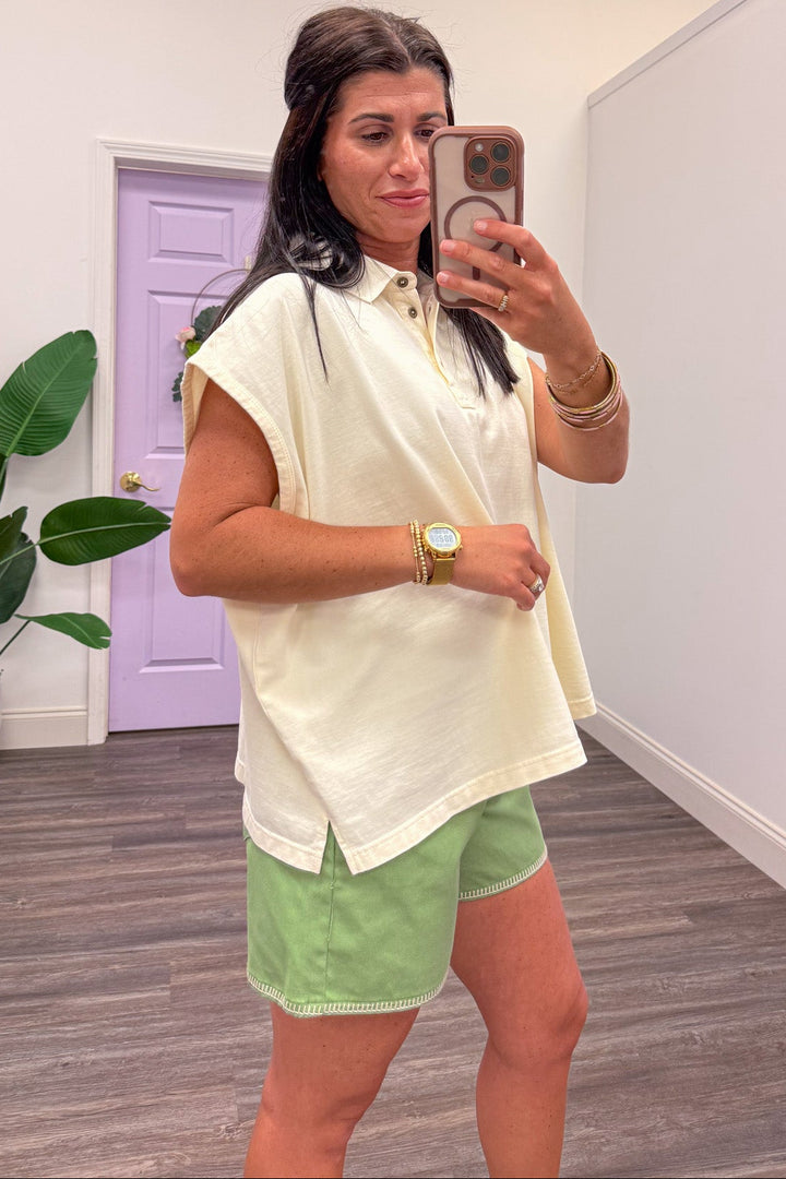 solid cream mineral washed cap sleeve polo top with bottom hem side slits