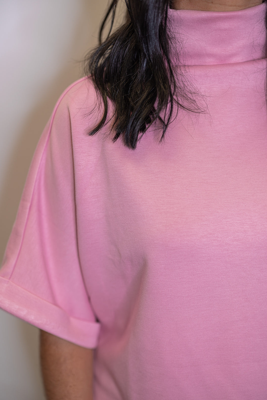 Women's light pink scuba knit top by Entro showing elevated mock neckline