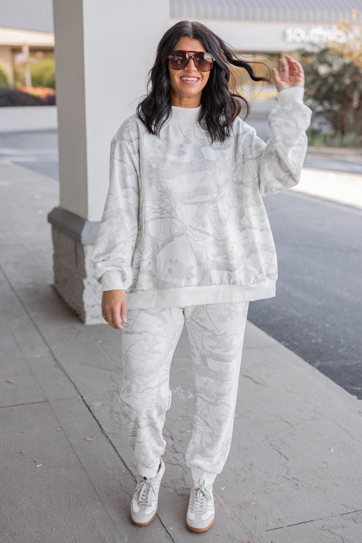 Women's grey snow camo joggers by BucketList shown with matching sweatshirt
