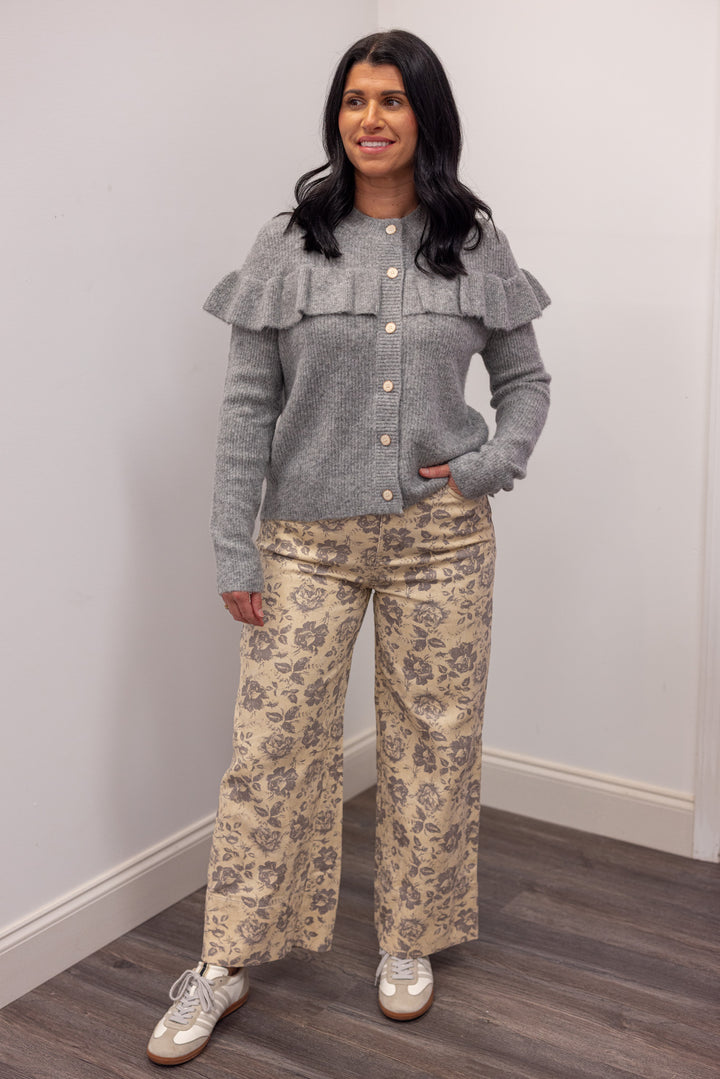 Women's grey knit sweater with a ruffle across the front chest and back shoulders by Wishlist showing full front view