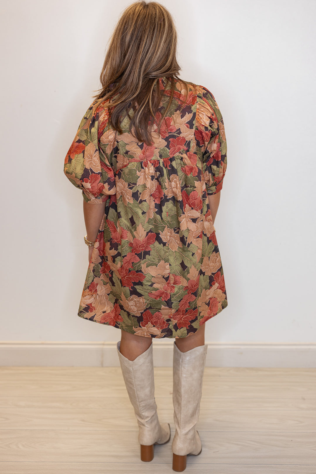 Women's brown babydoll dress with rusted burgundy, dusty peach and olive floral print by Entro showing full back view