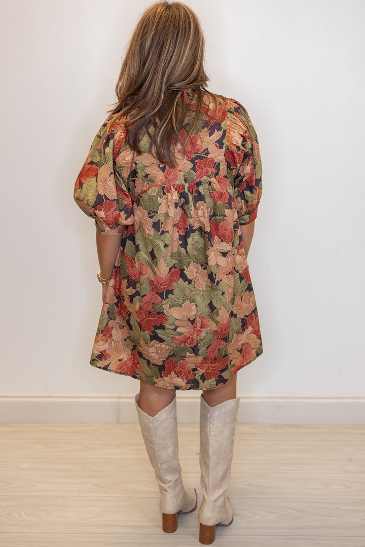 Women's brown babydoll dress with rusted burgundy, dusty peach and olive floral print by Entro showing full back view