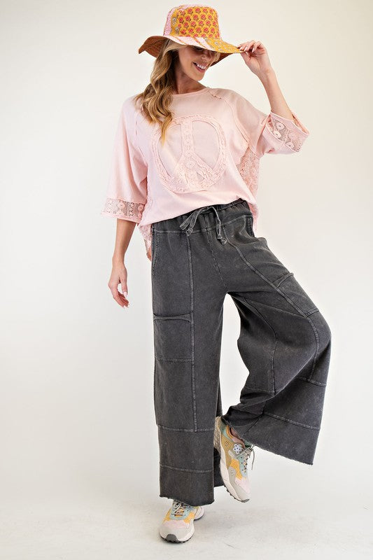Women's terry knit wide leg pants in mineral washed black by Easel showing full front view